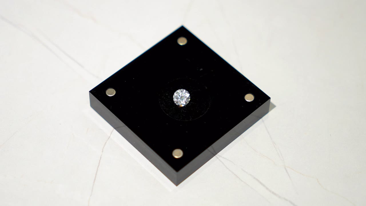 A real StarGen lab-grown diamond on its black magnetic base