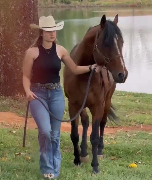 A StarGen client walking her horse, whose hoof became her diamond
